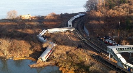 Four dead and 63 injured as all seven cars of a NYC commuter train fly off the rails
