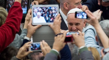 Pope Francis urges people to put away their iPhones