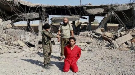 ISIS prisoner is 'executed by a child who shoots handcuffed man in the head'