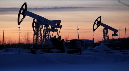 Oil jumps as sentiment gets boost, but analysts warn of ongoing glut