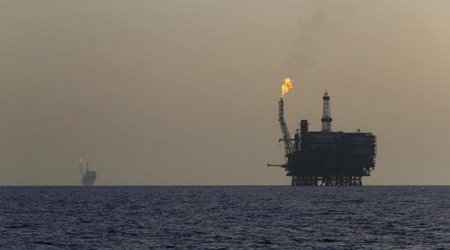 Oil prices fall on strong dollar, firm global supply