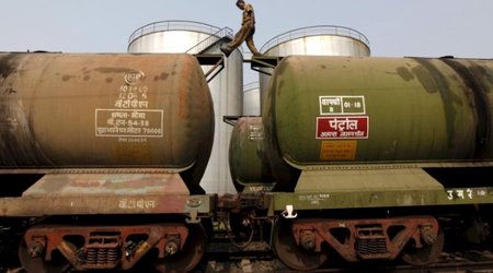 Oil rises on dollar weakness, but ample supplies cap gains