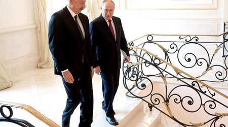 Aliyev and Putin shake hands in Beijing