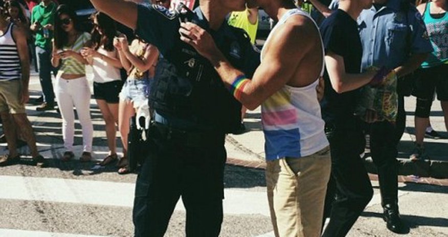 Moment a defiant police officer kissed his boyfriend - PHOTO Moment a defiant police officer kissed his boyfriend - PHOTO