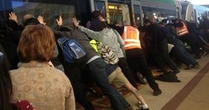 Passengers tilt train carriage to free man trapped in the gap Passengers tilt train carriage to free man trapped in the gap