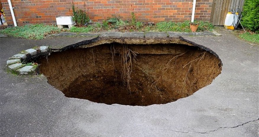 Sinkhole opens up yards from family's home Sinkhole opens up yards from family's home
