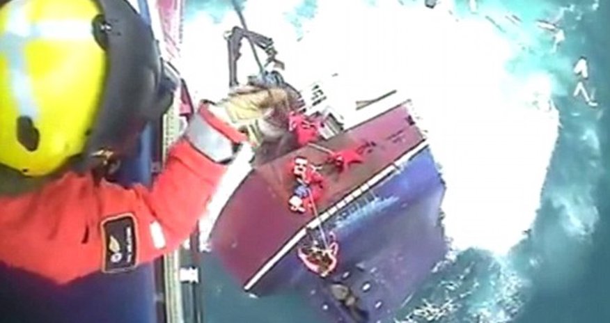 Dramatic footage shows moment fishermen cling Dramatic footage shows moment fishermen cling