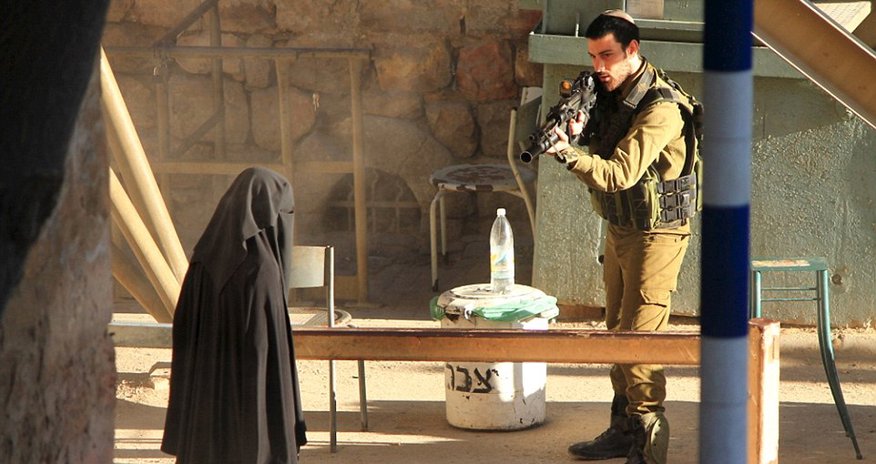 Israeli soldier pointed his rifle at veiled teenage Palestinian student... Israeli soldier pointed his rifle at veiled teenage Palestinian student...